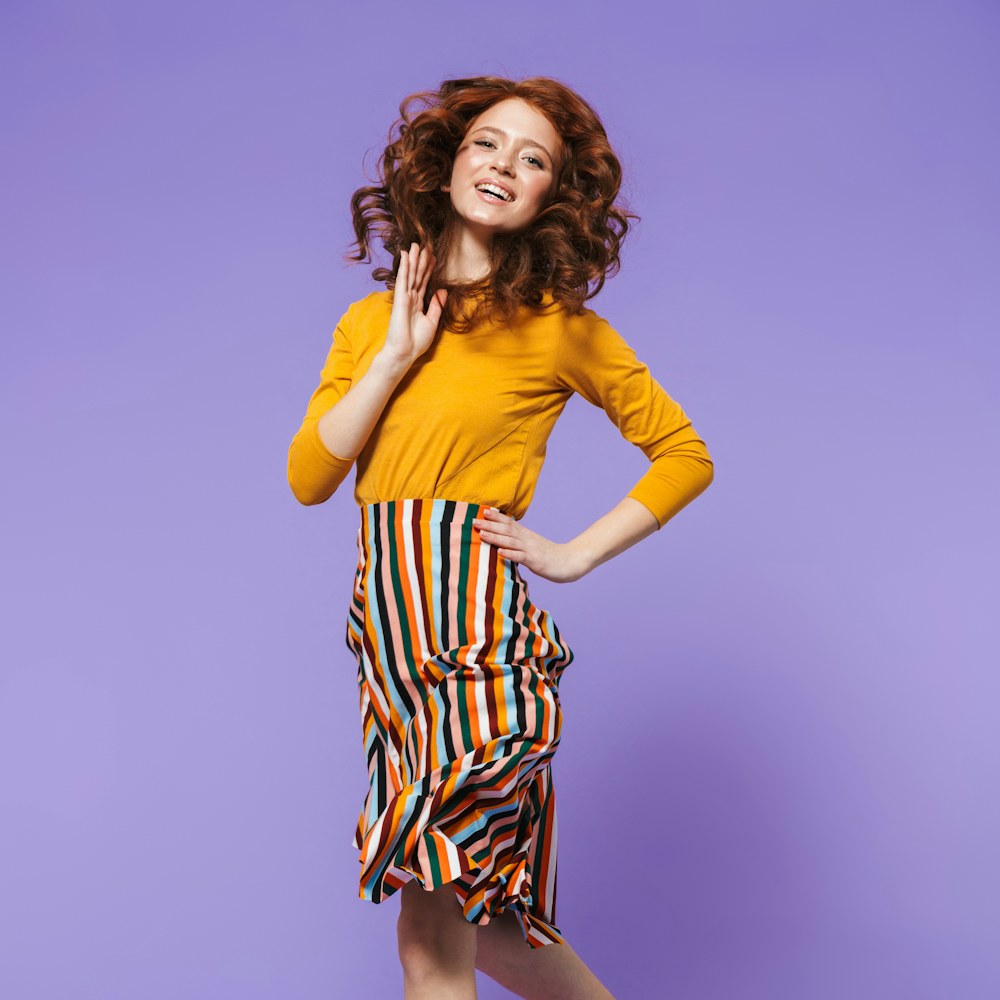 Woman dancing on a purple backdrop