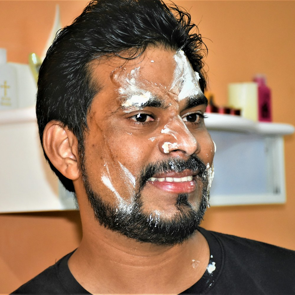 Man laughing with cream on his face