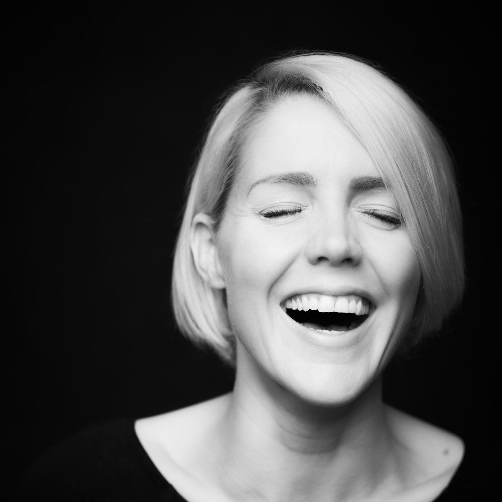 Black and white portrait of a woman laughing