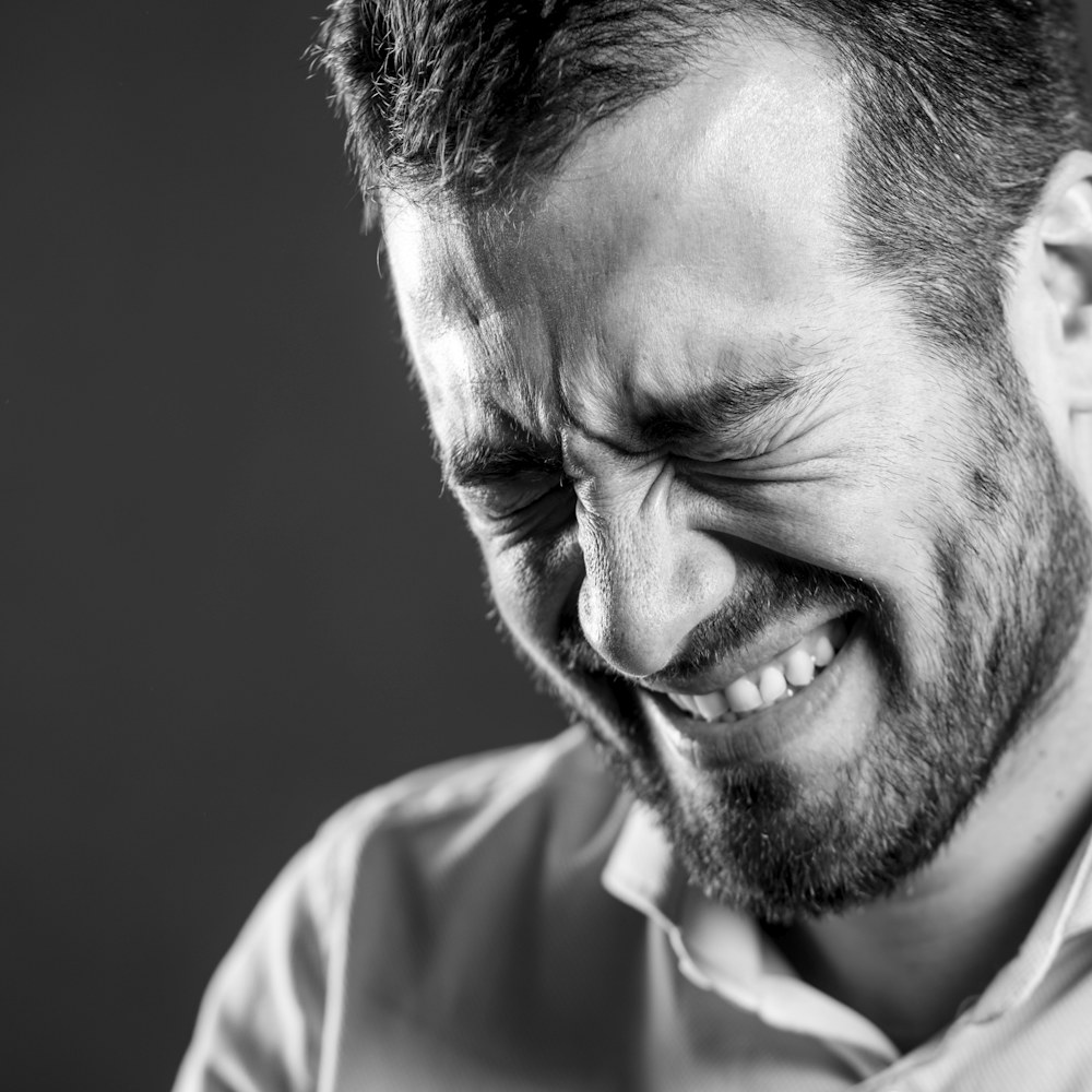 Black and white portrait of a man laughing